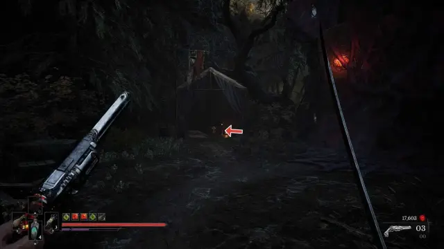 Tent and chest in the poison-hidden camp; dark frame with a small editorial arrow identifying the container.